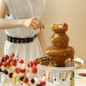 Fondue with a chocolate fountain and sweets for it.Sweet theme