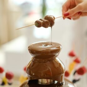 Fondue with a chocolate fountain and sweets for it.Sweet theme